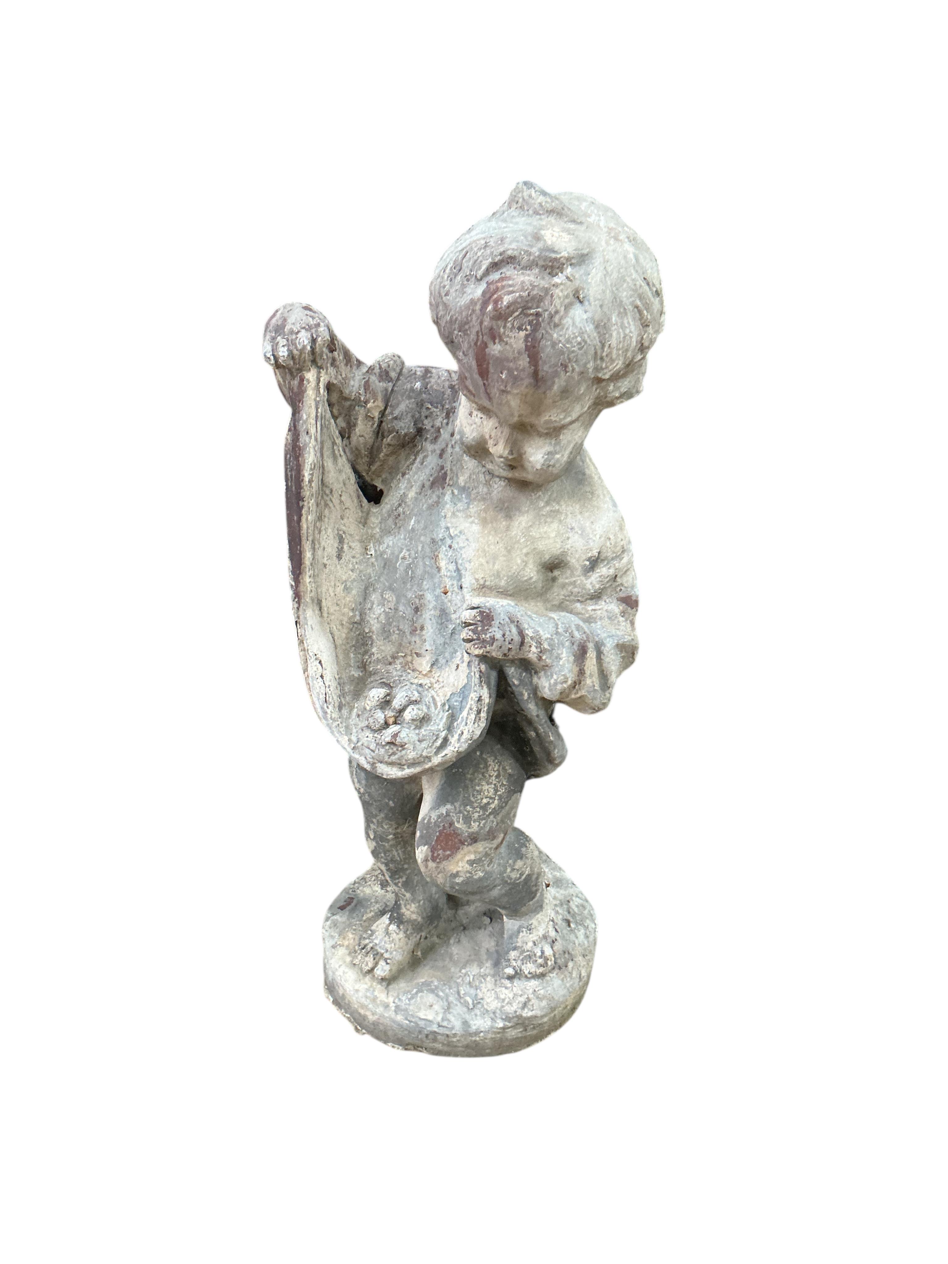 A pair of Victorian lead putti garden ornaments, larger height 48cm